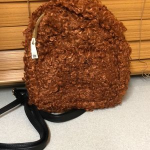 Reddish brown faux fur mini backpack